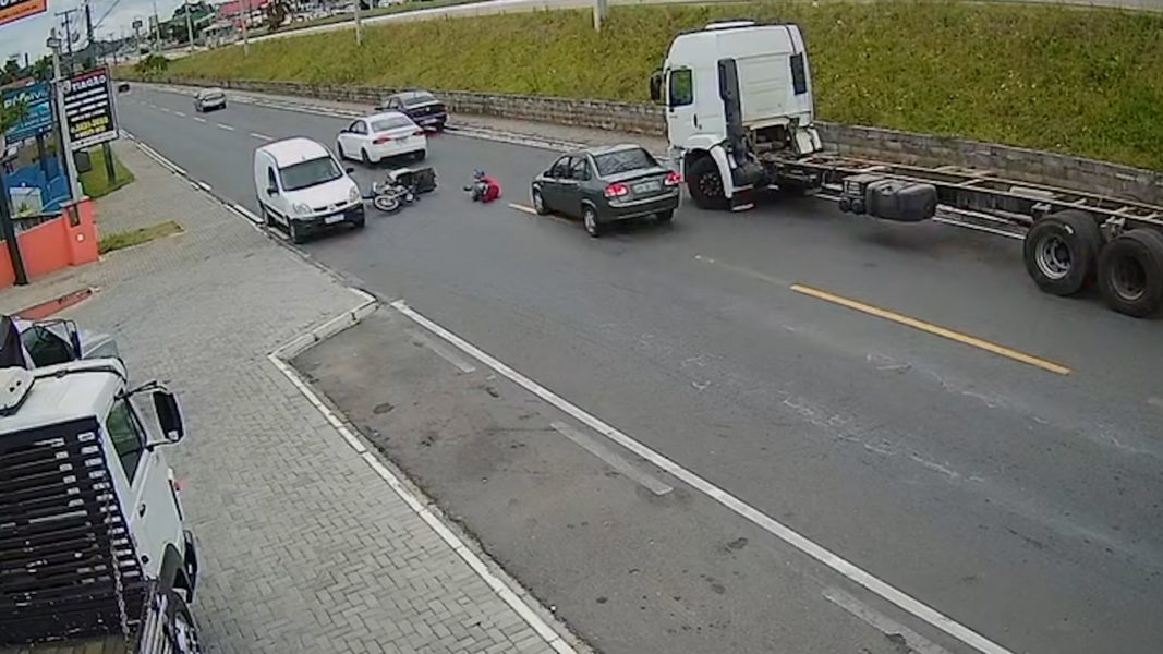 Vídeo: Motociclista bate em carro, cai da moto e quase é atropelado